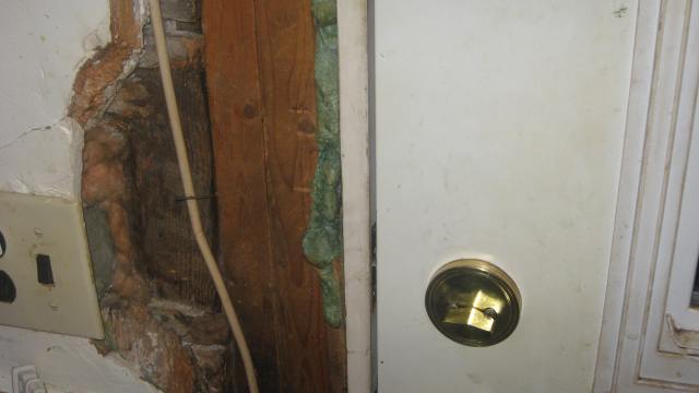 Main Door  to the left of the handle you can see where he knocked out drywall to do repairs